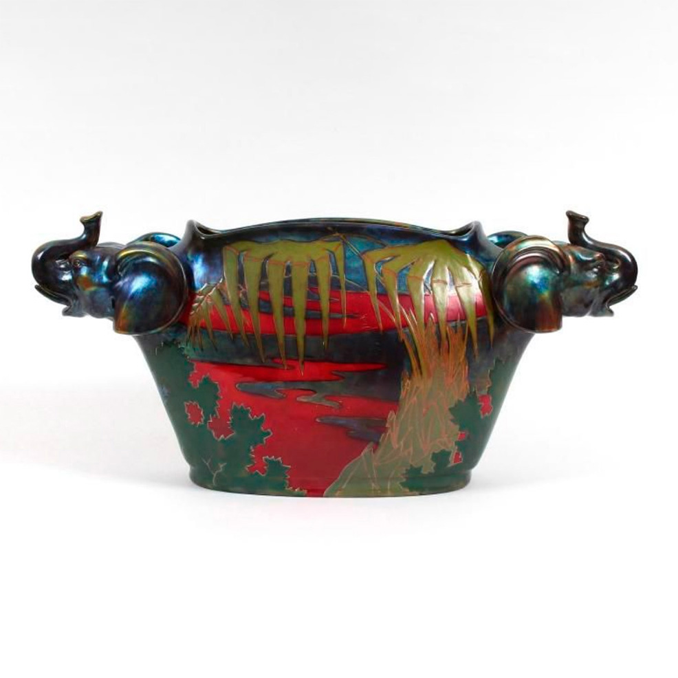 €23,400Vilmos Zsolnay, ceramic flower-pot holder with elephant-head handles, oxblood, tea-green and purple enameled slip, 24 x 55.5 x 14.5
