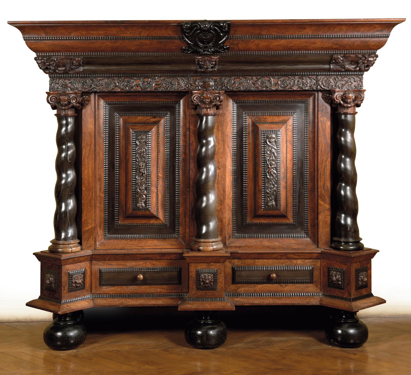 Dutch work, 17th century. Cabinet in rosewood with rosewood and ebony veneer decorated with masks and foliage, twisted columns, spherical 