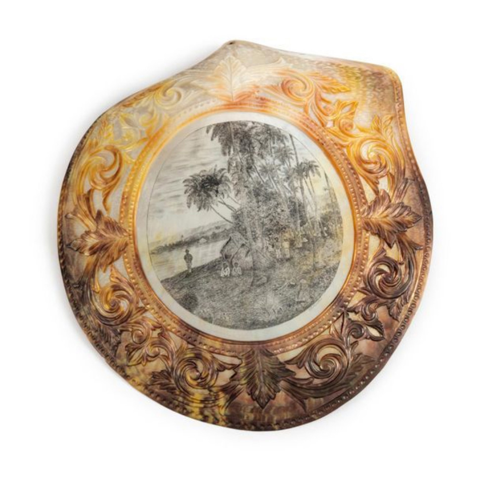 €2,688Joseph Muller, New Caledonia Penal Colony, late 19th century, pearl oyster engraved with a village of huts beneath palm trees, 22.6 
