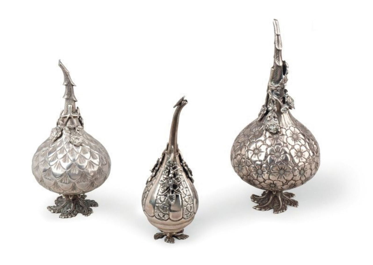 €576Ottoman Empire, 20th century, three silver gülabdan sprinklers, two decorated with chased flowers, the other with scales, punches, h. 