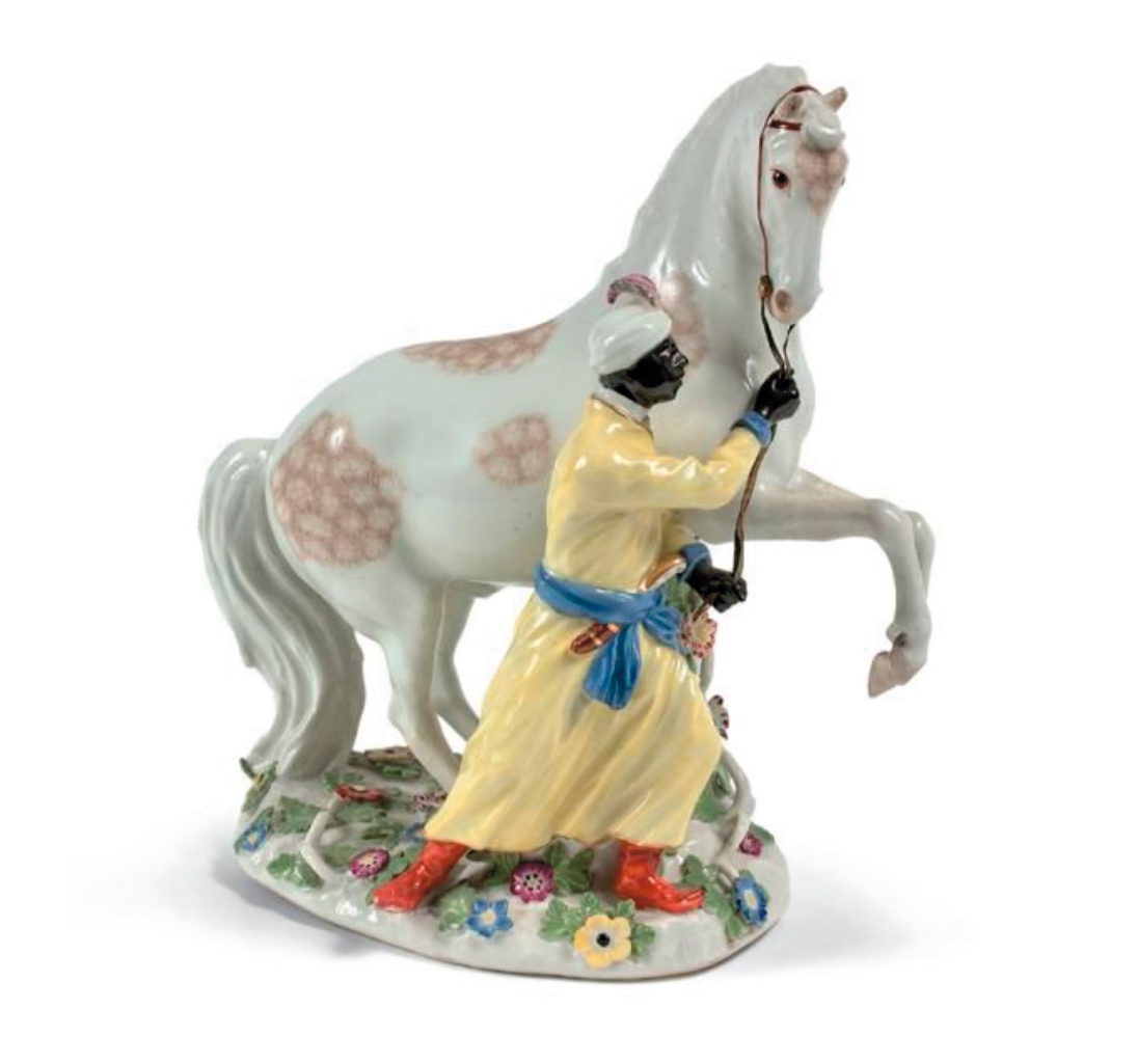 7 596 € Meissen, vers 1750. Groupe représentant un Africain en costume oriental tenant un cheval cabré sur un socle ovale orné de fleurs e