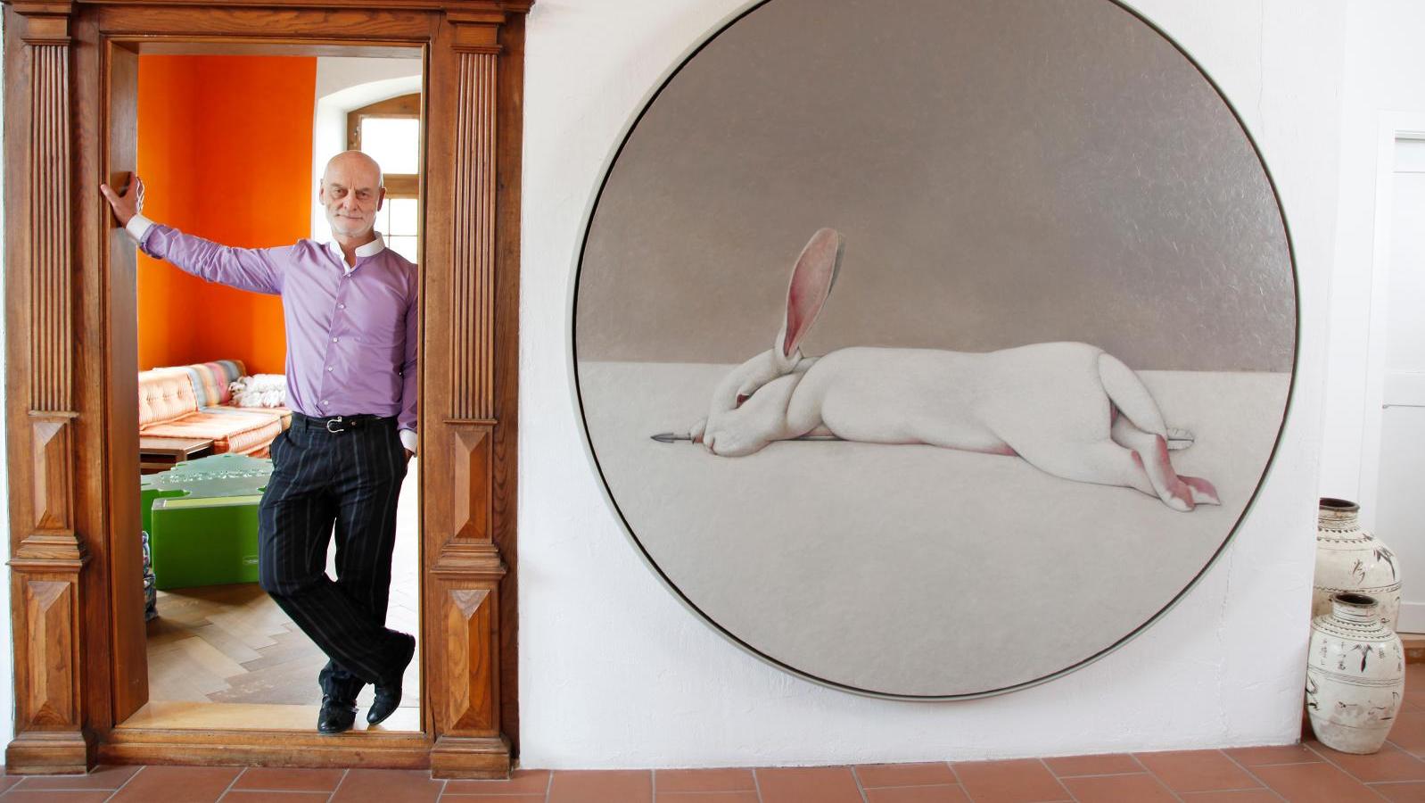 Uli Sigg poses beside a painting by Fan Shao Uli Sigg: When Chinese Art Becomes Globalized 
