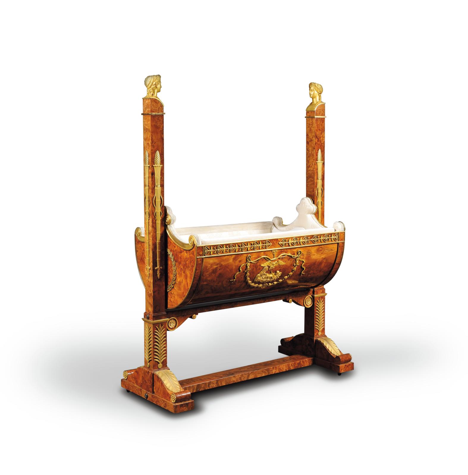 €257,600F.-H.-G. Jacob-Desmalter, after drawings by C. Percier., rocking cradle in elm burr veneer richly decorated with chased gilt bronz