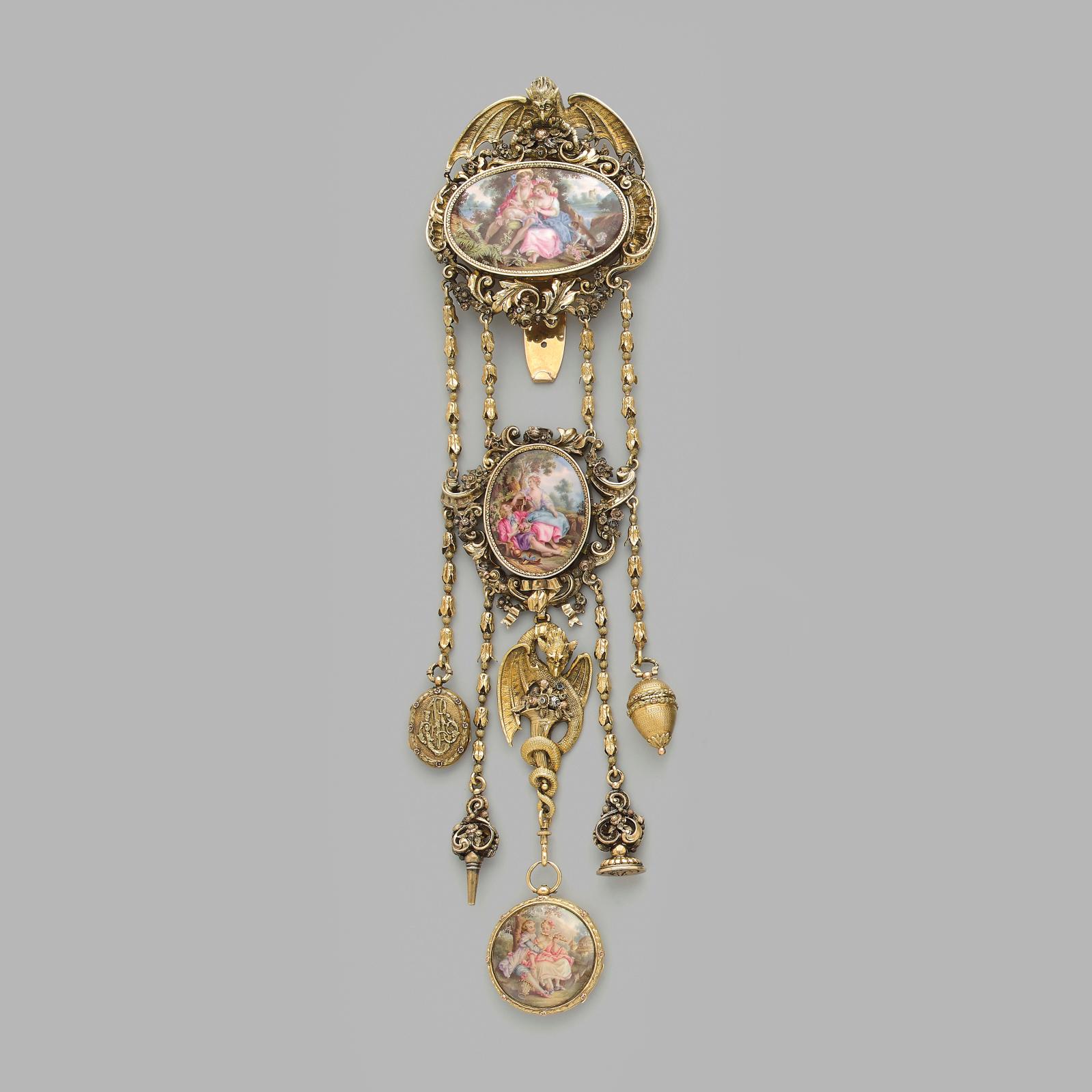 €6,60418th century, chatelaine in openwork gold in several colors with decoration of a chimera, dragon, agraffes with foliage and floral b