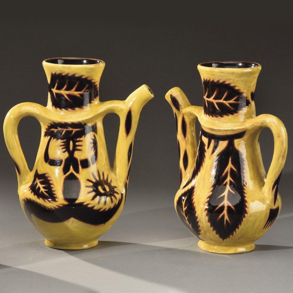 €1,750Jean Lurçat and Sant Vicens, pair of conically shaped ceramic pitchers featuring figures and foliage, h. 30 cm (11.82 in).Lyon, Cona
