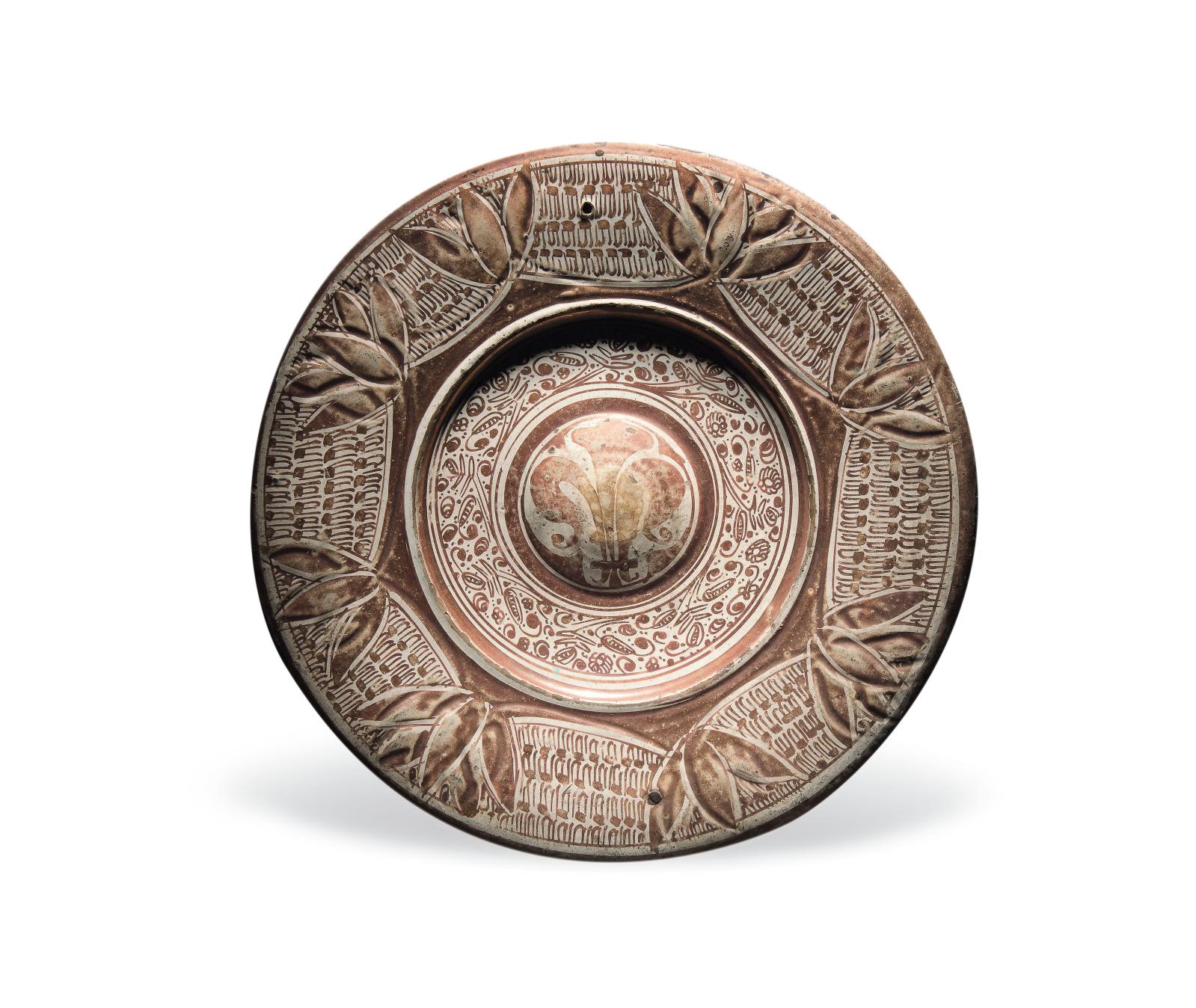 Round earthenware dish with embossment, buff background with ochre luster decoration with a fleur-de-lys in the center and stylized foliag