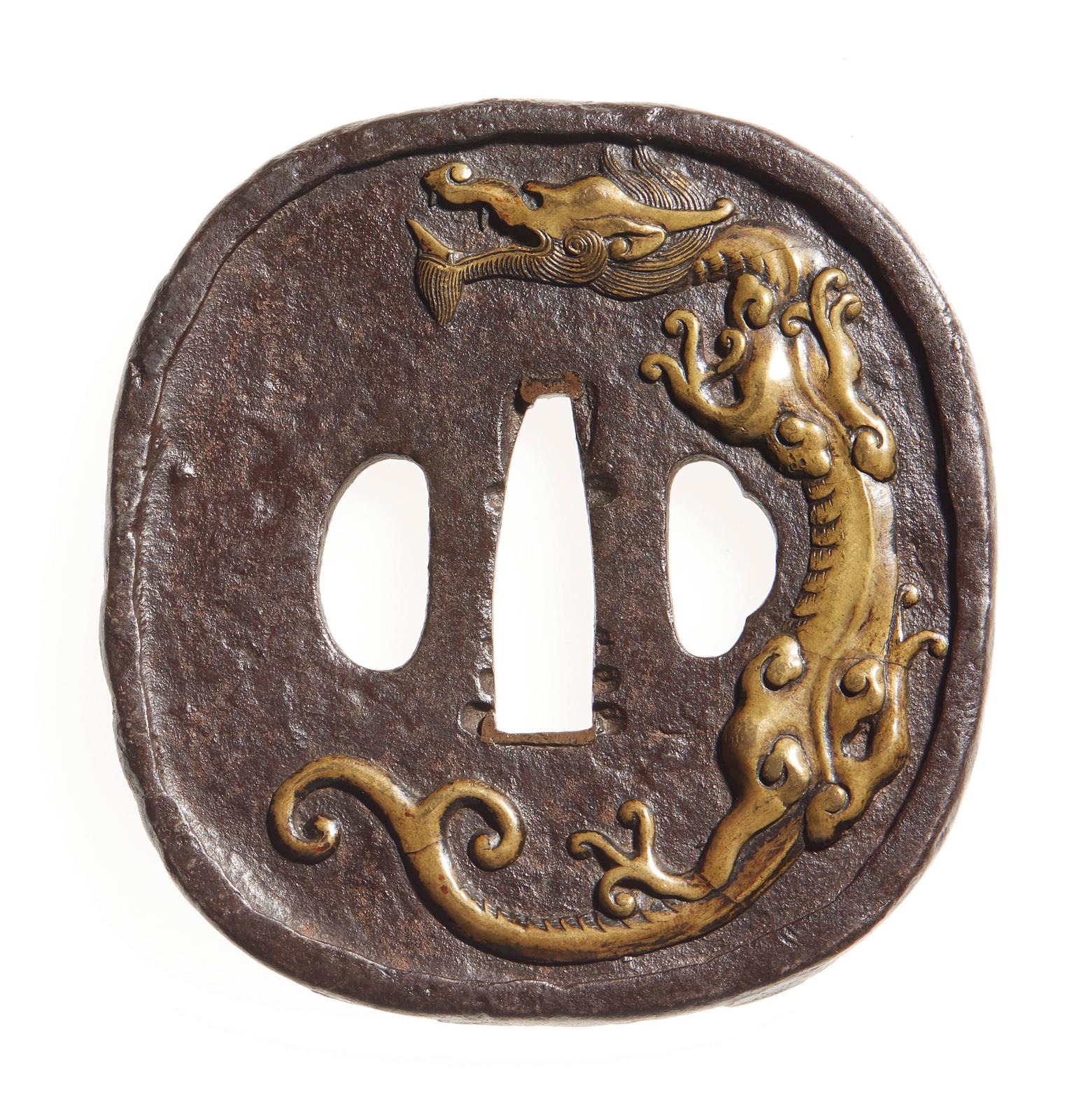 Début de l’époque Edo (1603-1868). Hokei gata en fer à décor incrusté en taka zogan de laiton, d’un dragon sur une face et d’un phénix aux ailes déplo
