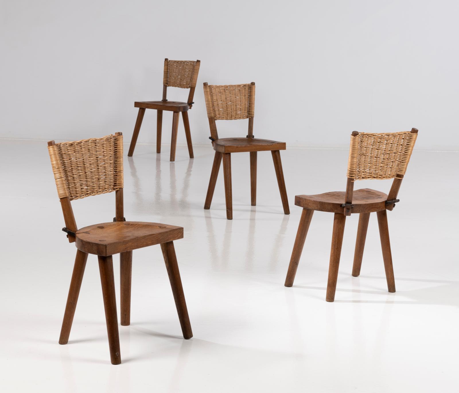 Jean Touret et Les Artisans de Marolles, suite de quatre chaises, vers 1955, chêne travaillé à la gouge, rotin et fer forgé, 79 x 44 x 36 